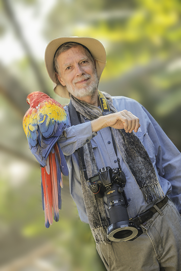 Mayan Toons Dr Nicholas Hellmuth with a scarlet macaw